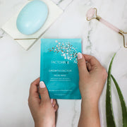 FACTORFIVE's Growth Factor Post Treatment Mask being shown in inviting home setting, with other wellness accessories, facial roller, gua sha