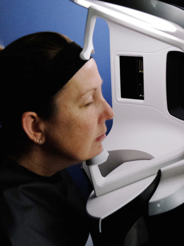 Female patient getting their face scanned by FACTORFIVE's Visa machine