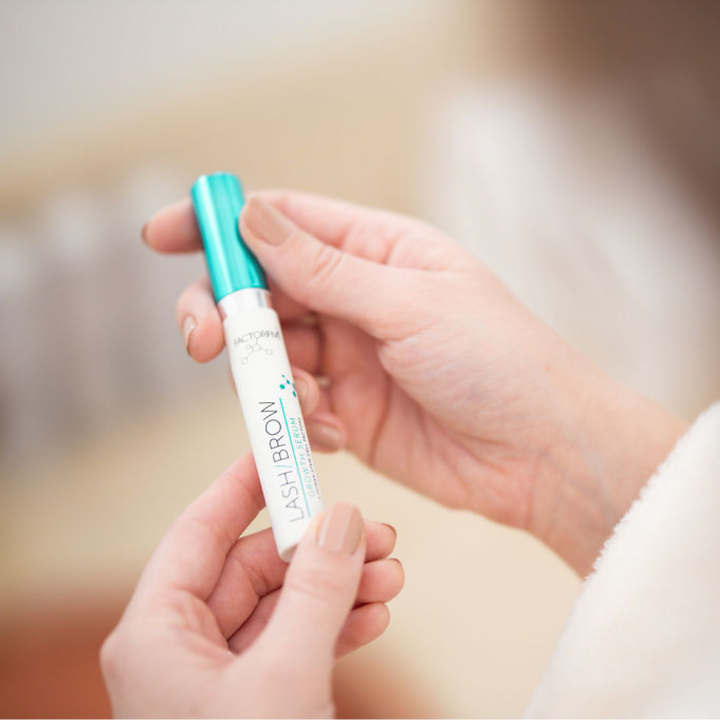 Woman holding FACTORFIVE Lash/Brow Growth Serum